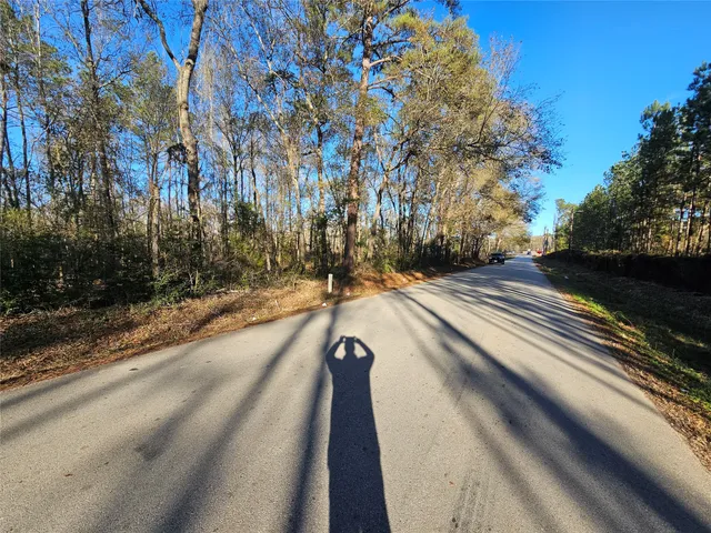 a view of a street with a building in the background