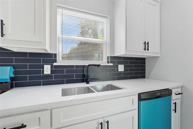 a kitchen with a sink and cabinets