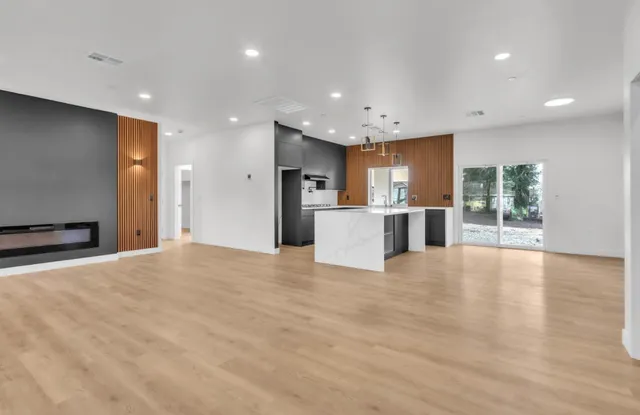 a view of a kitchen with a sink and a large window