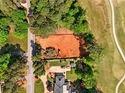 an aerial view of a residential houses with yard