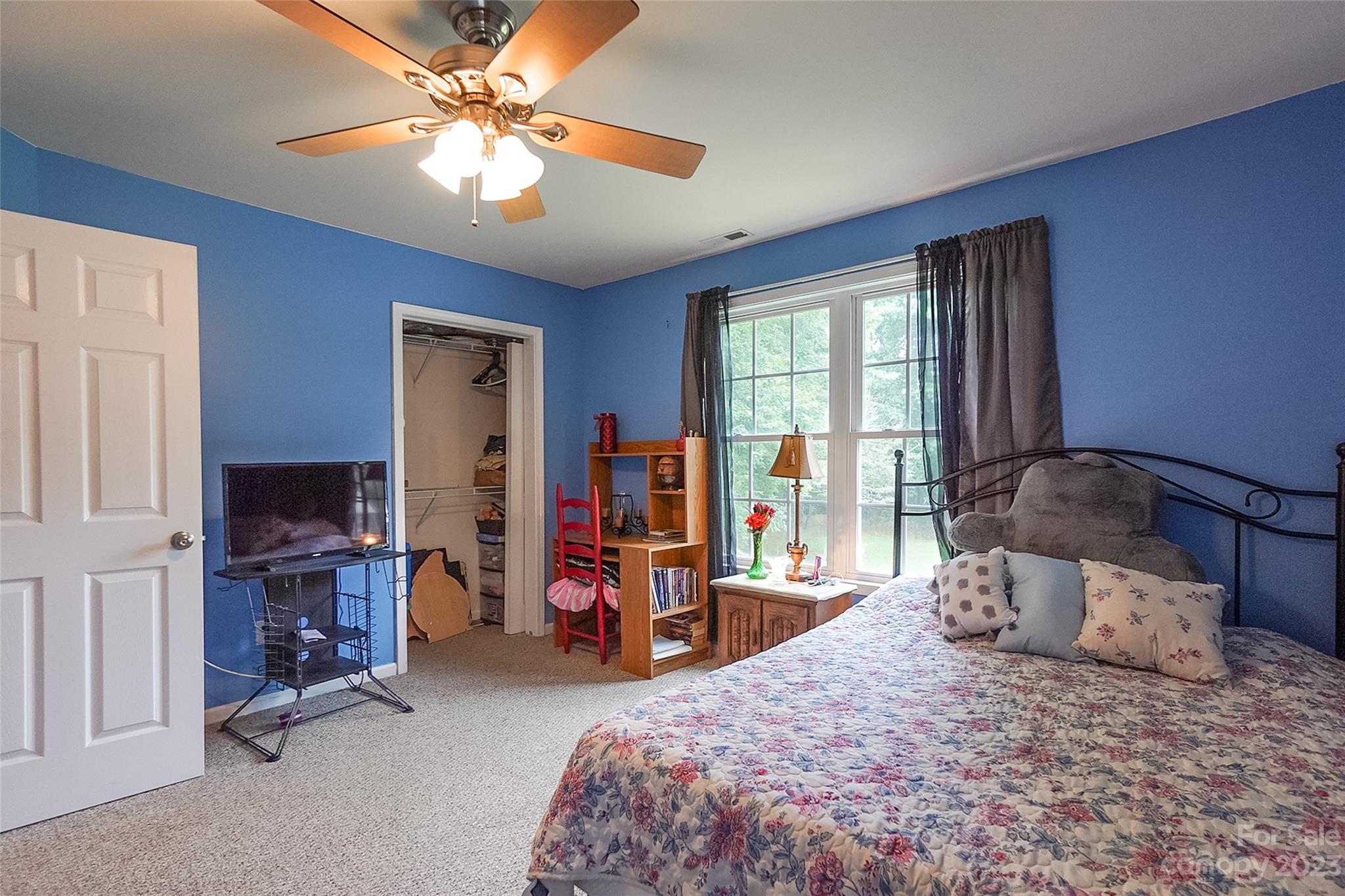 2070 Smithford Road Hickory Grove, SC 29717 - Photo 27 of 39 a bedroom with a bed a large window and flat screen tv