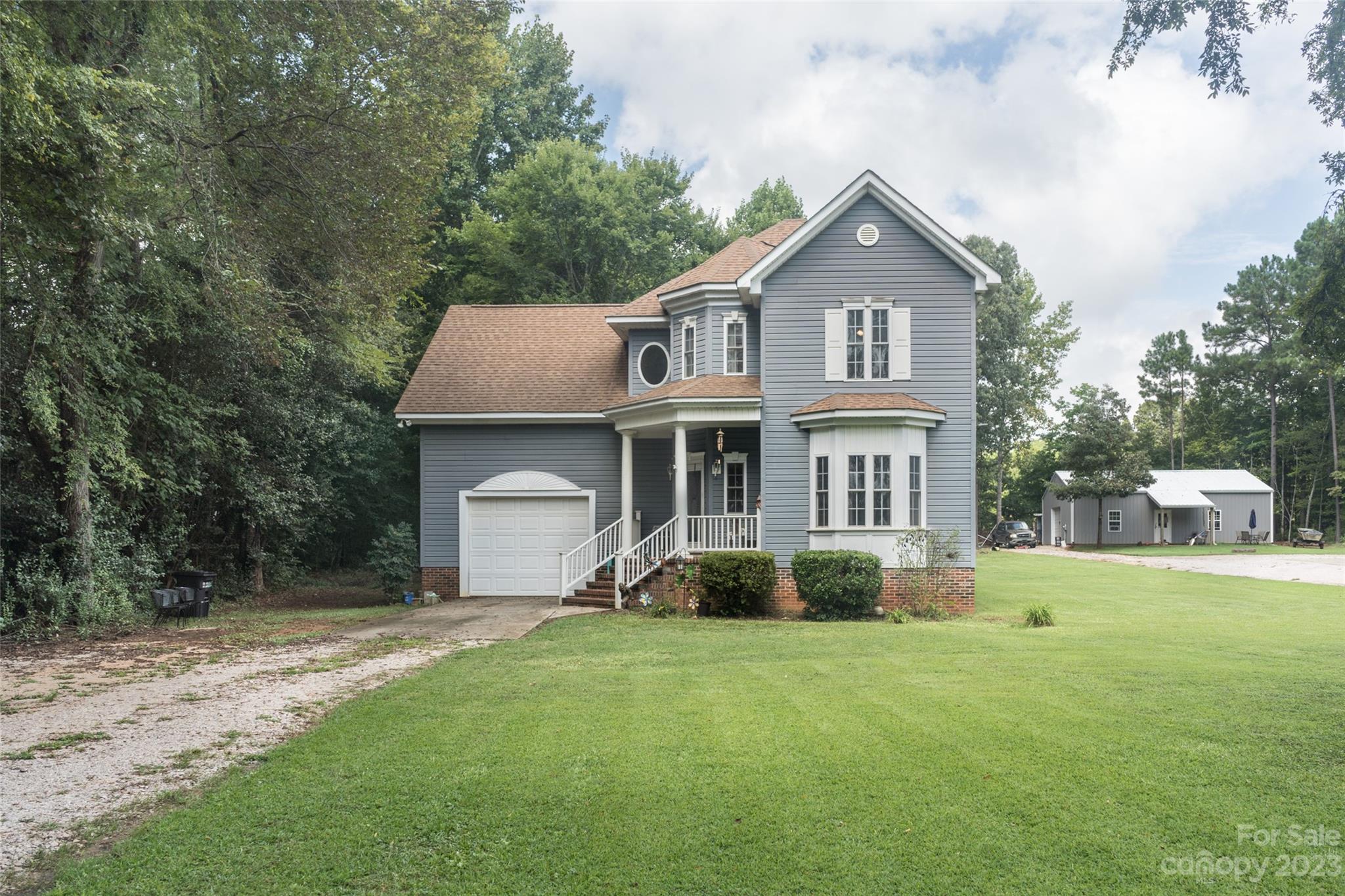 2070 Smithford Road Hickory Grove, SC 29717 - Photo 3 of 39 a front view of a house with a garden