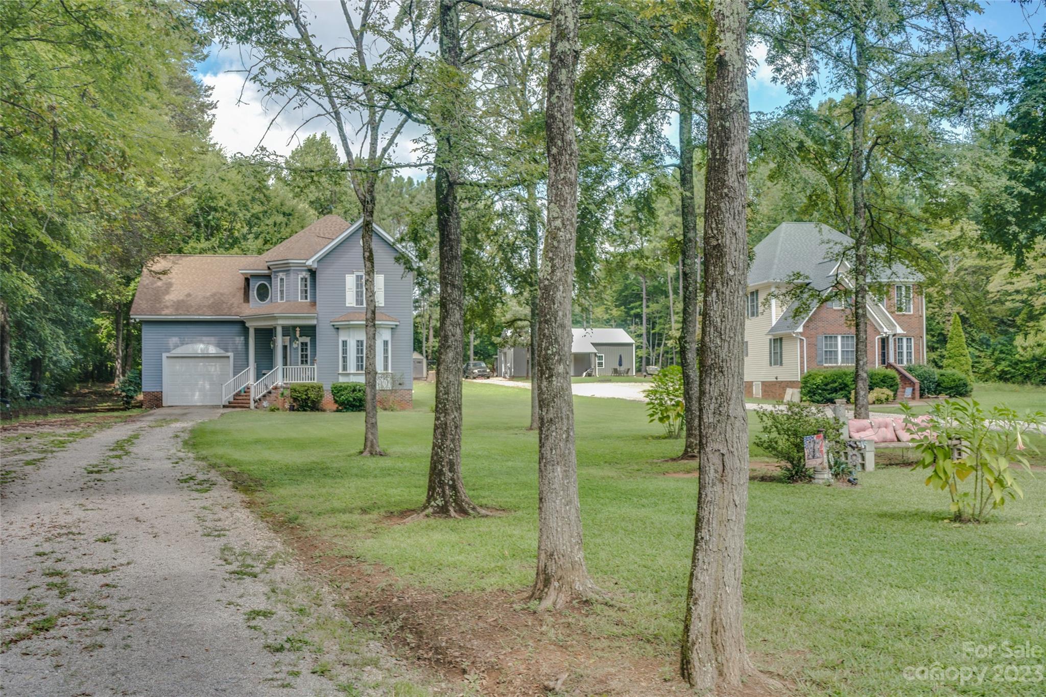 2070 Smithford Road Hickory Grove, SC 29717 - Photo 5 of 39 a view of a house with a big yard plants and large trees