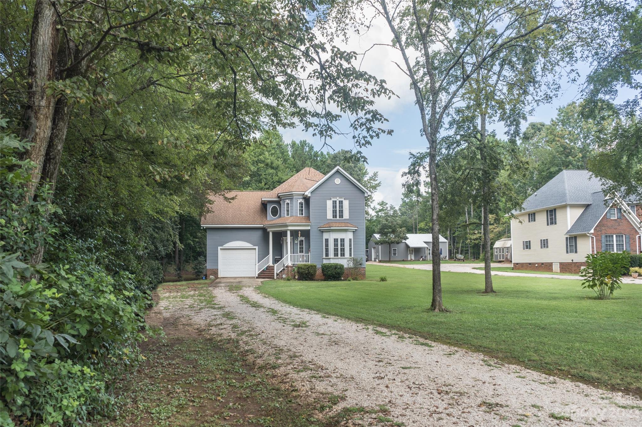 2070 Smithford Road Hickory Grove, SC 29717 - Photo 6 of 39 a front view of a house with a yard