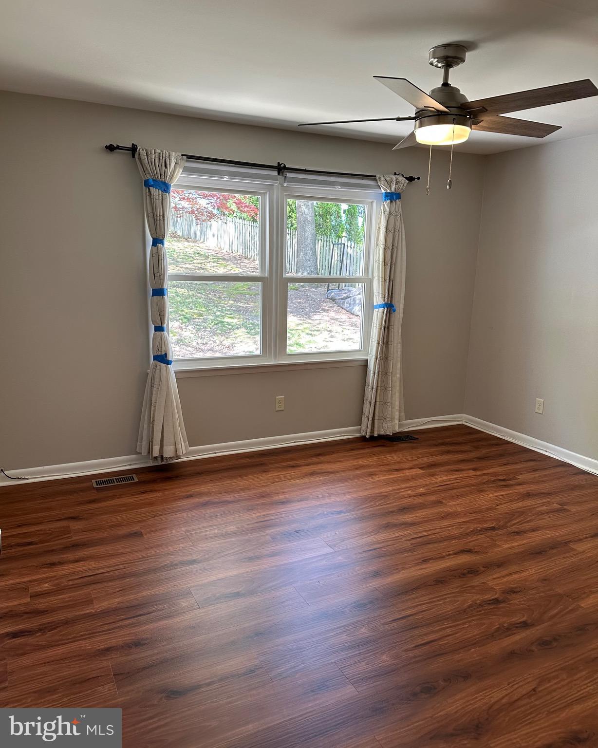 6020 Hanover Road Hanover, MD 21076 - Photo 36 of 42 an empty room with wooden floor fan and windows