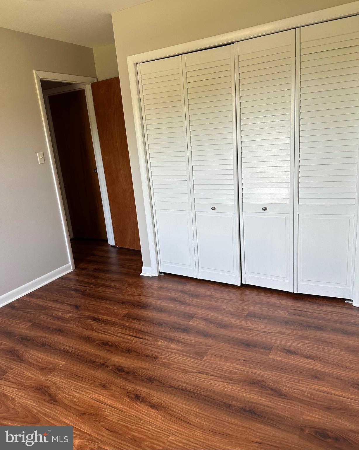 6020 Hanover Road Hanover, MD 21076 - Photo 41 of 42 a view of an empty room with wooden floor and a window