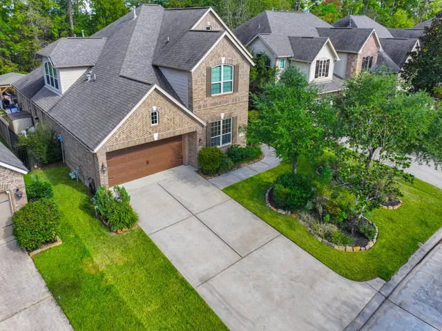 a aerial view of a house with a yard and plants