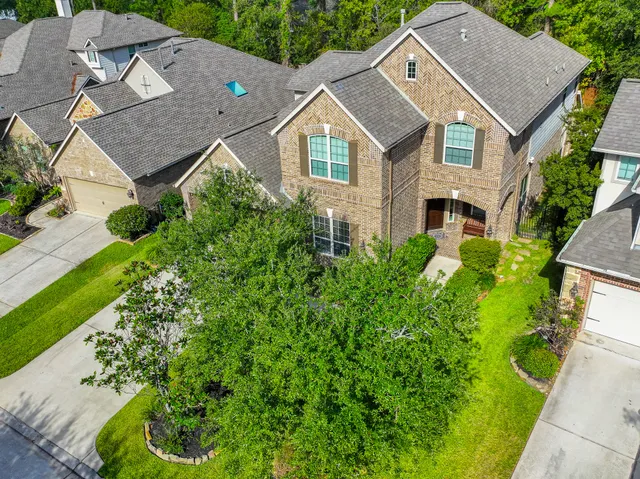 an aerial view of a house with a garden and yard