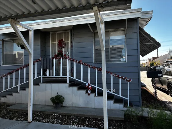 a view of a dining room with furniture and a chandelier