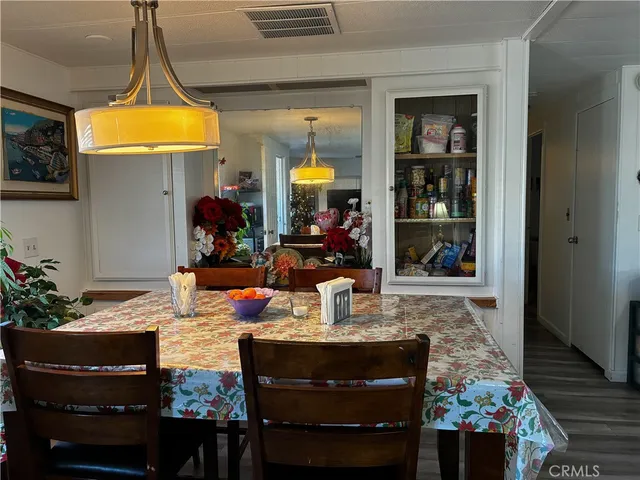 a view of a kitchen area with furniture and wooden floor