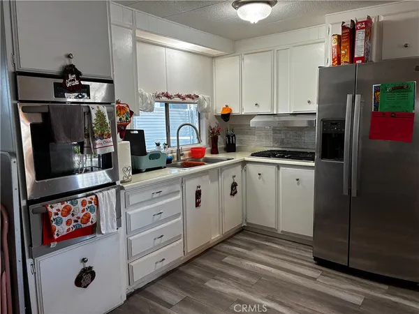 a kitchen with stainless steel appliances a refrigerator and a stove