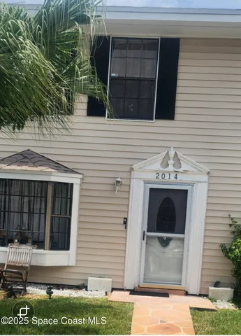 a view of front door and potted plants