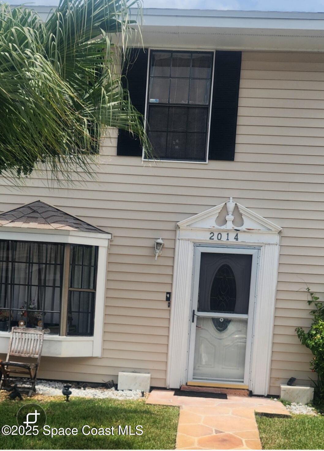 a view of front door and potted plants
