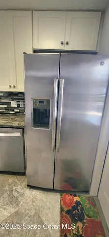 a kitchen with a refrigerator and a stove