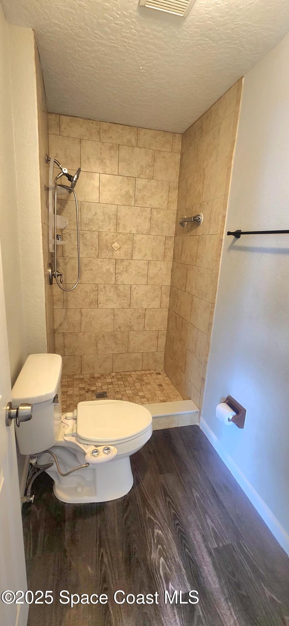 2014 Manor Drive Northeast Palm Bay, FL 32905 - Photo 20 of 24 a bathroom with a toilet and a shower