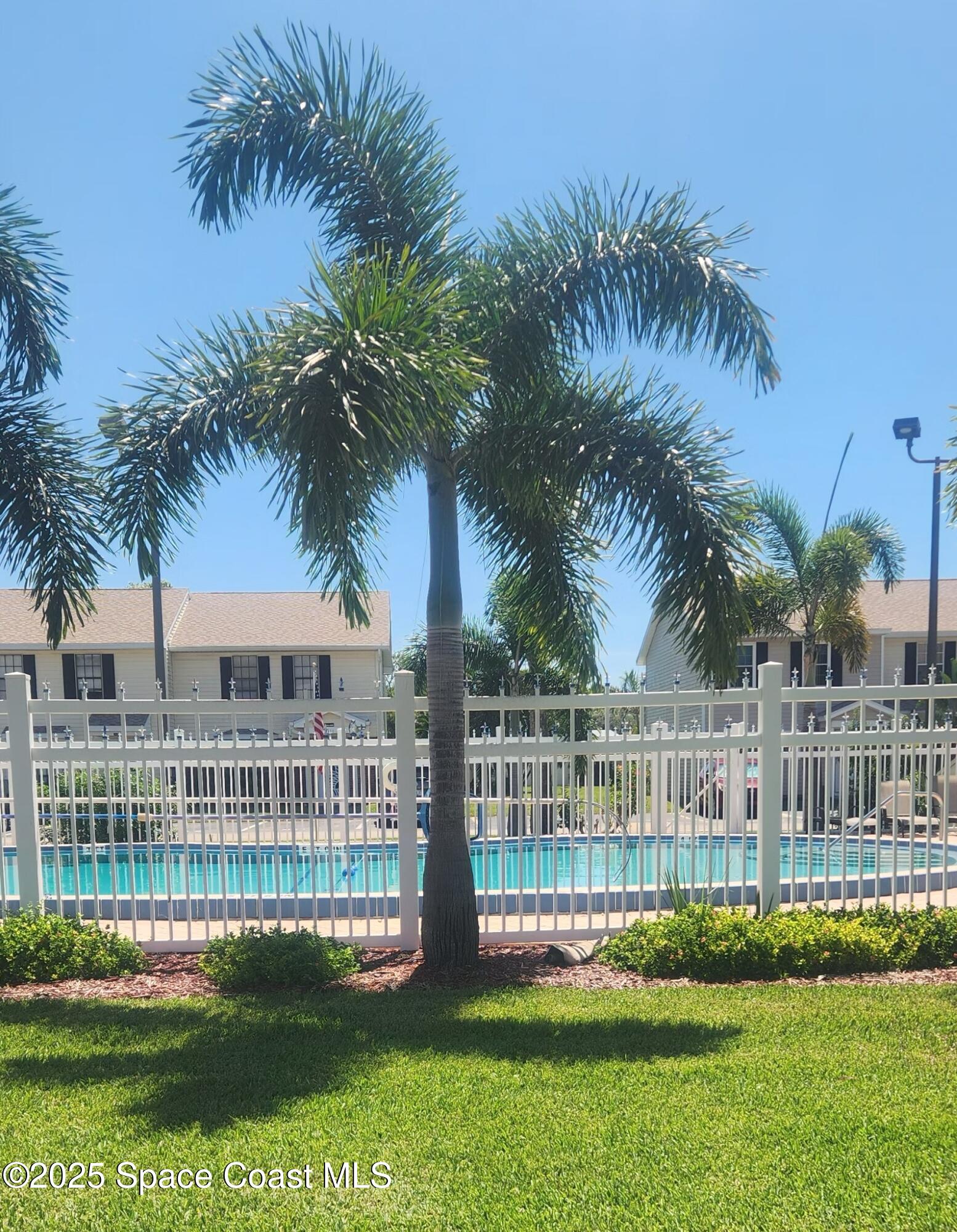 2014 Manor Drive Northeast Palm Bay, FL 32905 - Photo 2 of 24 a view of a house with a garden and trees