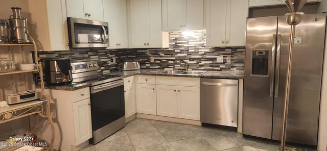 a kitchen with a sink stove and refrigerator