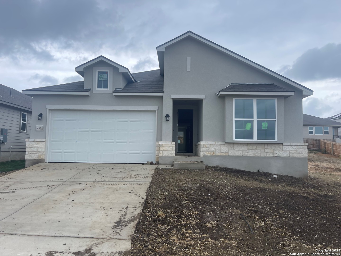 a front view of a house with a yard and garage