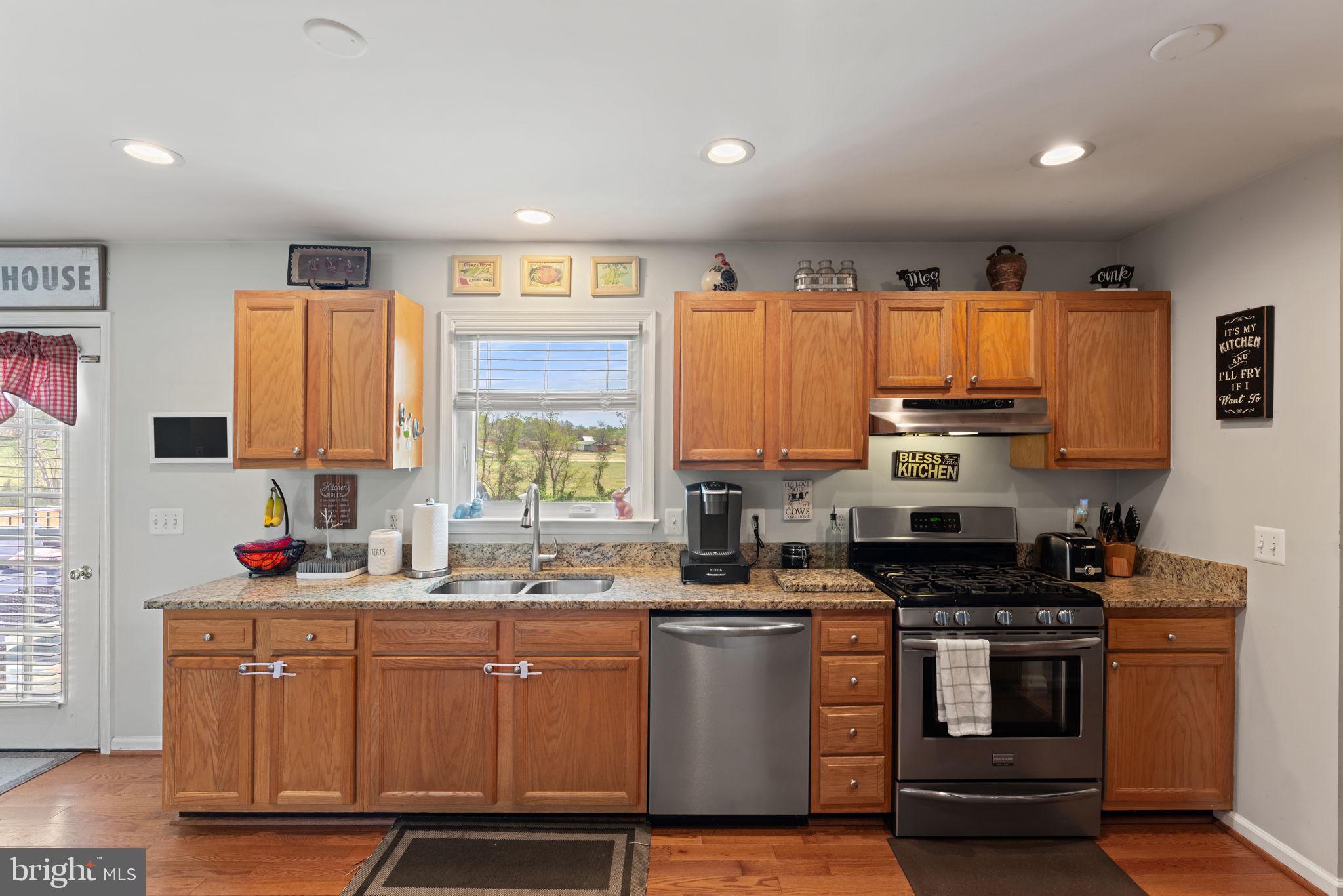 1388 Novum Church Road Reva, VA 22735 - Photo 21 of 65 a kitchen with stainless steel appliances a sink stove and cabinets