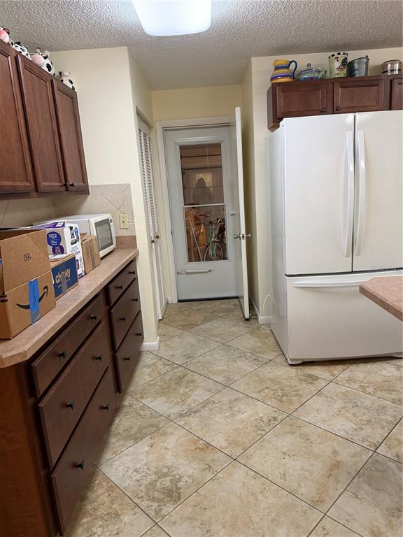 9529 Southwest 85th Avenue, Unit D Ocala, FL 34481 - Photo 8 of 21 a kitchen with stainless steel appliances a refrigerator and a cabinets