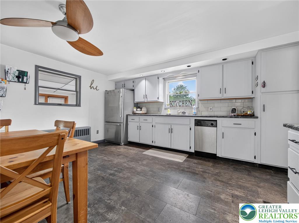 2628 Levans Road Coplay, PA 18037 - Photo 15 of 54 A compact kitchen with sleek appliances and practical dark flooring awaits culinary endeavors.