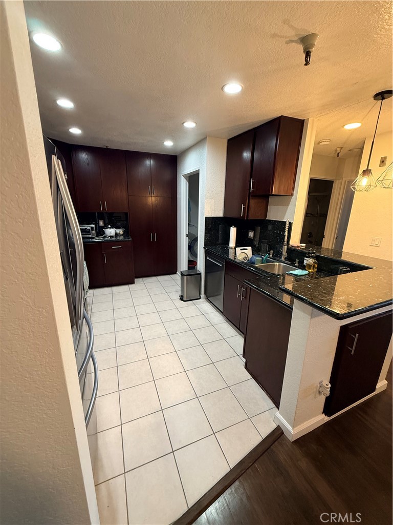 14630 Dickens Street, Unit 307 Sherman Oaks, CA 91403 - Photo 11 of 41 a kitchen with stainless steel appliances a refrigerator sink and microwave