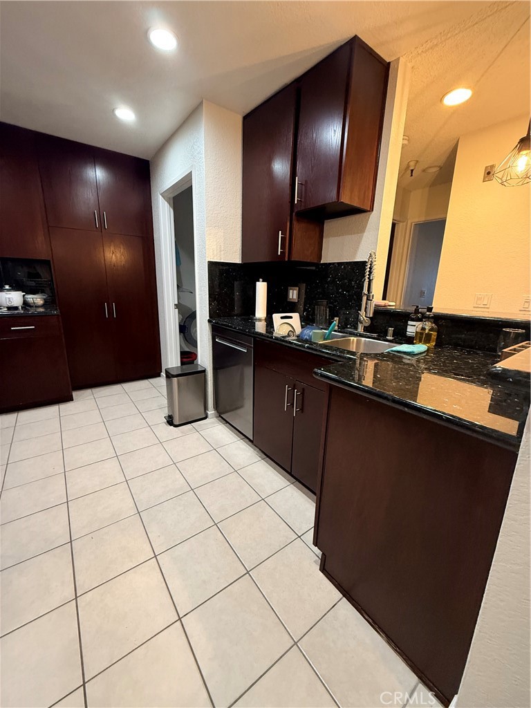 14630 Dickens Street, Unit 307 Sherman Oaks, CA 91403 - Photo 13 of 41 a kitchen with stainless steel appliances kitchen island granite countertop a refrigerator and a stove