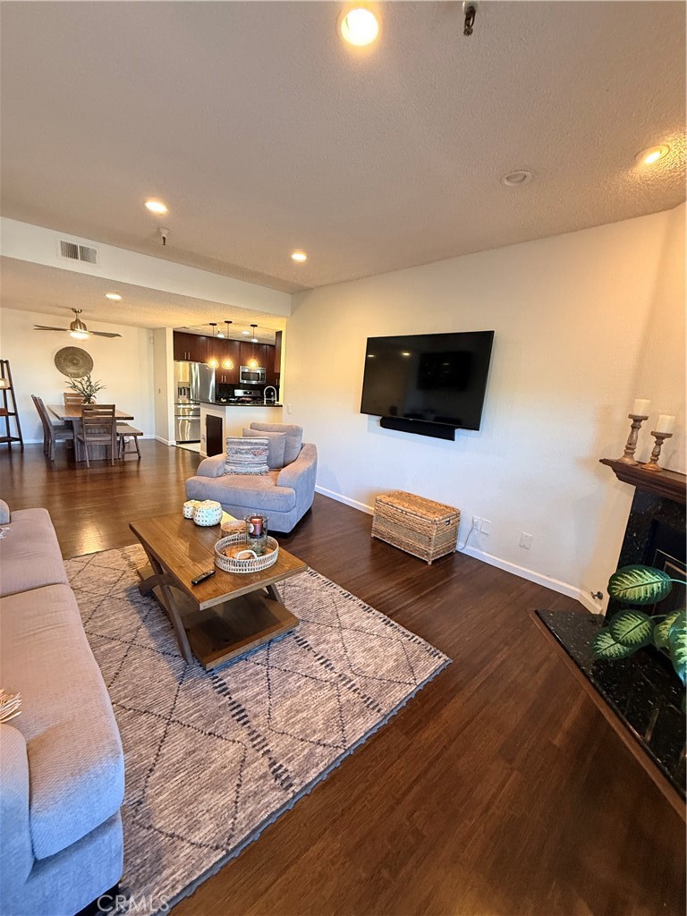 14630 Dickens Street, Unit 307 Sherman Oaks, CA 91403 - Photo 20 of 41 a living room with furniture and a flat screen tv