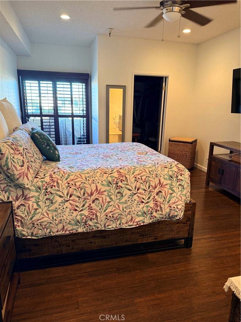 14630 Dickens Street, Unit 307 Sherman Oaks, CA 91403 - Photo 27 of 41 a bedroom with a large bed and wooden floor