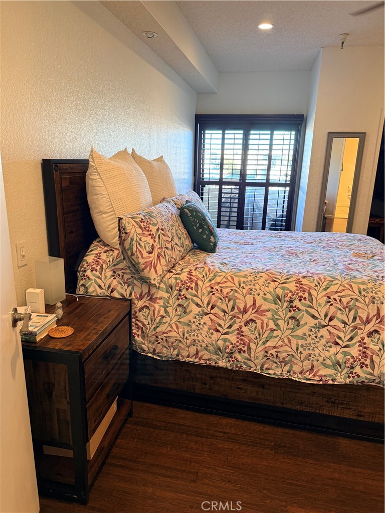 14630 Dickens Street, Unit 307 Sherman Oaks, CA 91403 - Photo 28 of 41 a bedroom with a bed and wooden floor