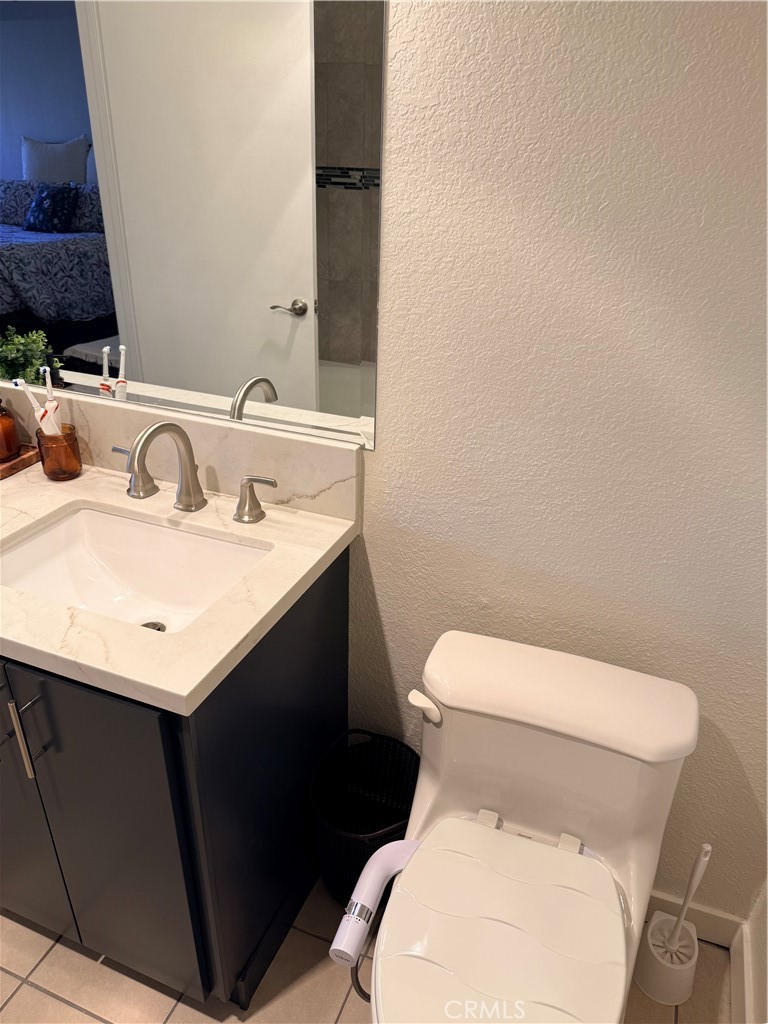 14630 Dickens Street, Unit 307 Sherman Oaks, CA 91403 - Photo 33 of 41 a white toilet sitting next to a bathroom sink