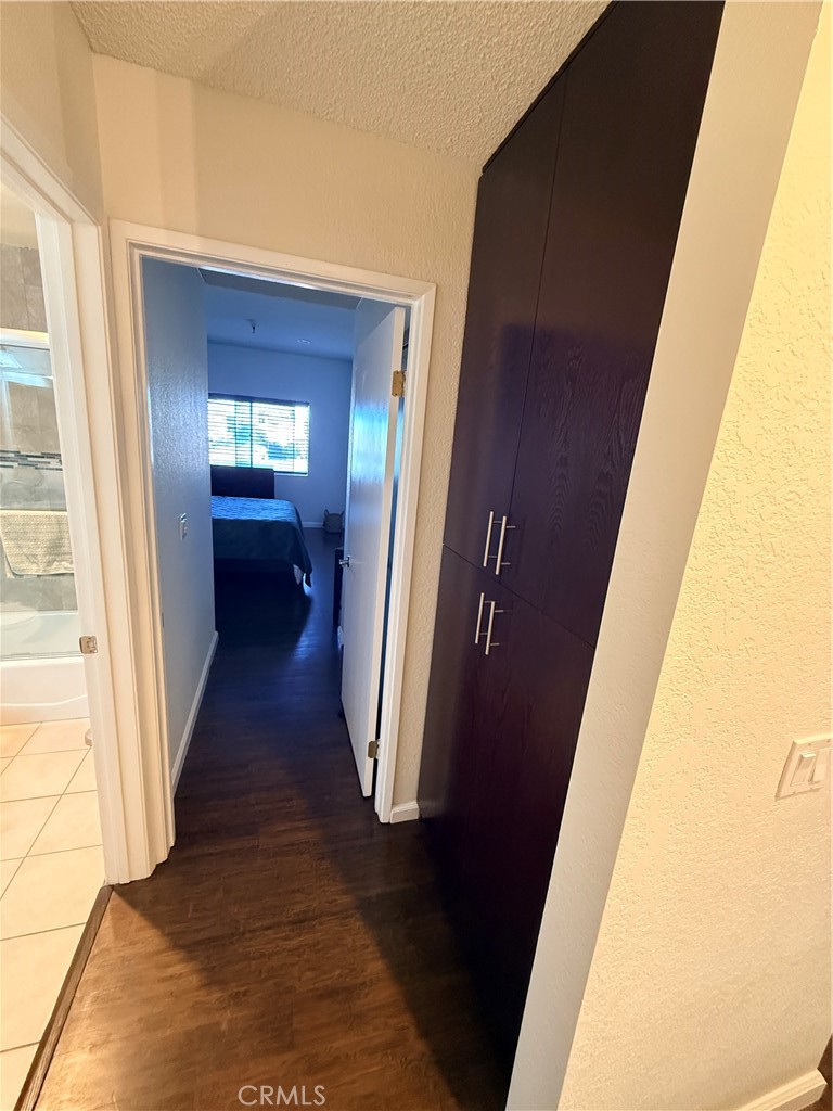 14630 Dickens Street, Unit 307 Sherman Oaks, CA 91403 - Photo 36 of 41 a view of a hallway with wooden floor and staircase