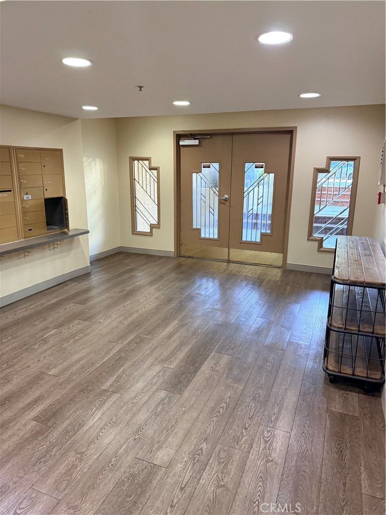 14630 Dickens Street, Unit 307 Sherman Oaks, CA 91403 - Photo 4 of 41 an empty room with wooden floor and window