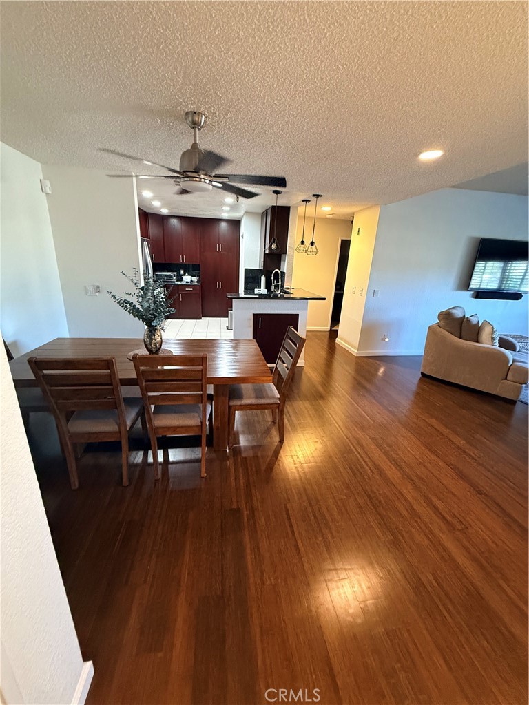 14630 Dickens Street, Unit 307 Sherman Oaks, CA 91403 - Photo 8 of 41 a living room with furniture and a wooden floor