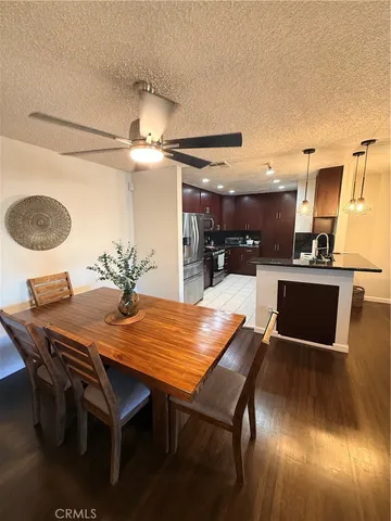 a kitchen with stainless steel appliances kitchen island granite countertop a refrigerator and a stove