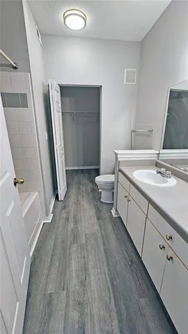 a spacious bathroom with a sink and mirror