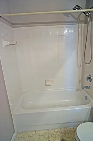 a bathroom with a shower and a bath tub