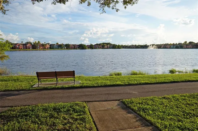 a front view of a house with swimming pool and furniture