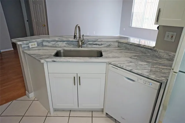 a kitchen with a sink and cabinets