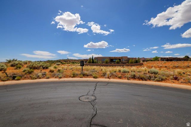 Basalt Cir Street, Unit 1027 St. George, UT 84770 - Photo 14 of 29 View of asphalt street featuring curbs