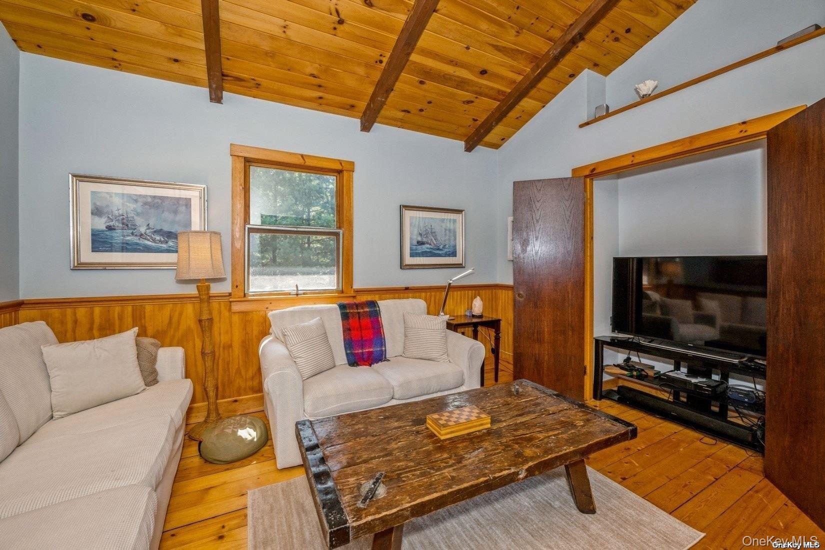 292 Little Fresh Pond Road Southampton, NY 11968 - Photo 20 of 46 a living room with furniture and a flat screen tv