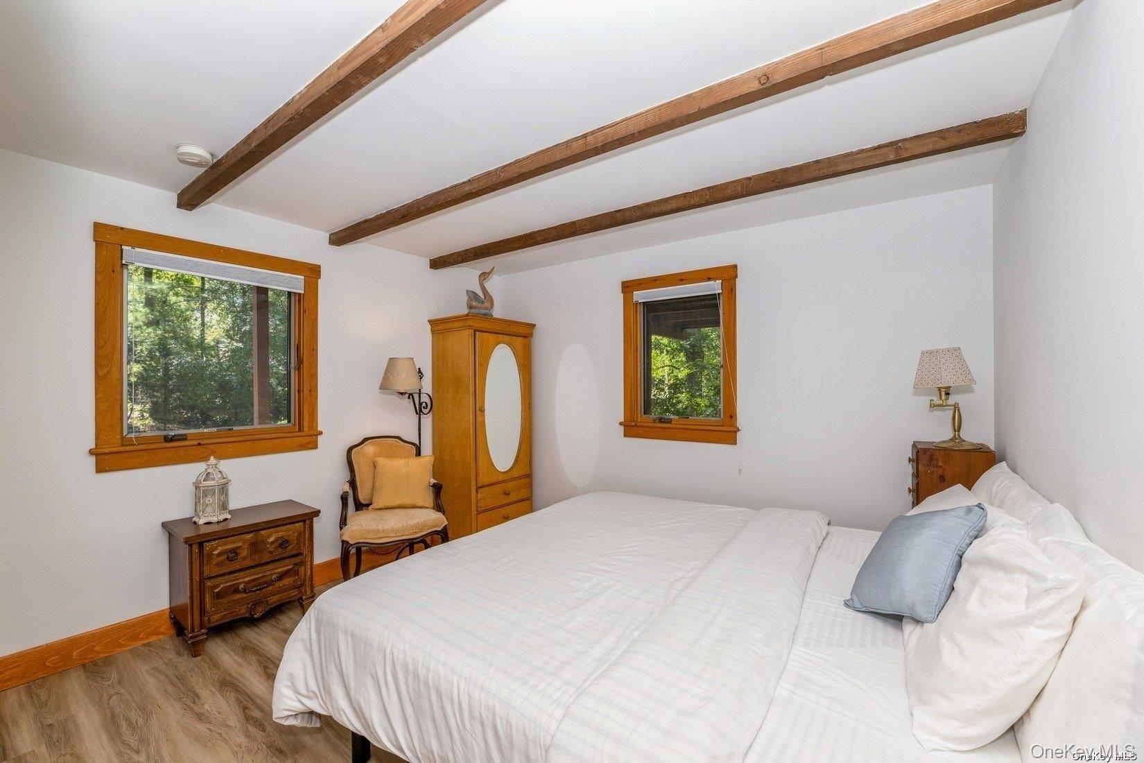 292 Little Fresh Pond Road Southampton, NY 11968 - Photo 33 of 46 a bedroom with a bed and a dresser next to a window