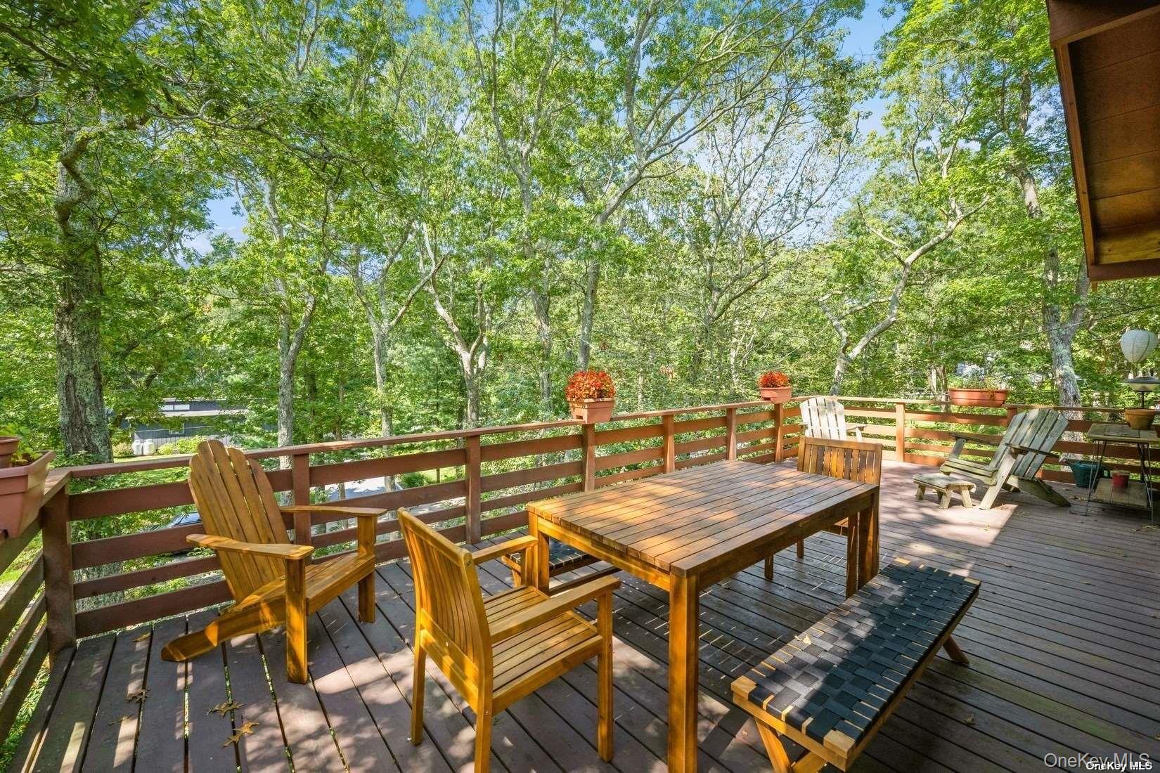 292 Little Fresh Pond Road Southampton, NY 11968 - Photo 8 of 46 a view of a patio with table and chairs and wooden floor