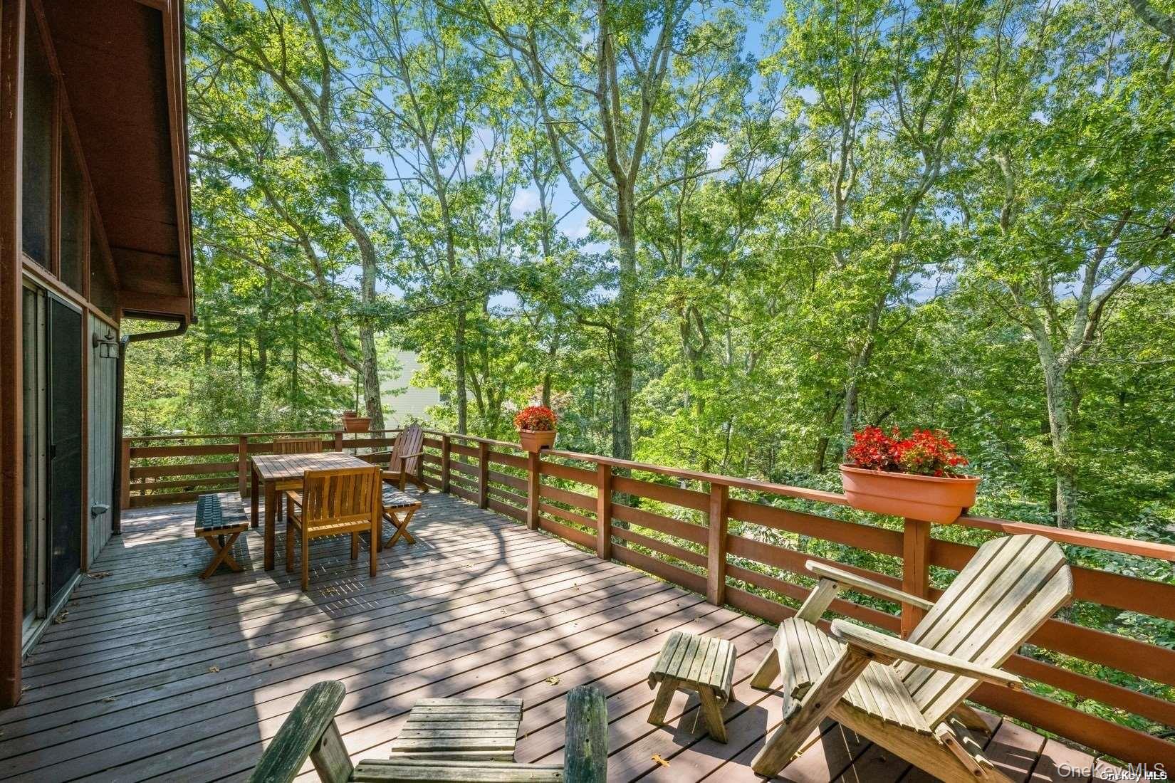 292 Little Fresh Pond Road Southampton, NY 11968 - Photo 9 of 46 a view of a patio with table and chairs potted plants with wooden floor and fence