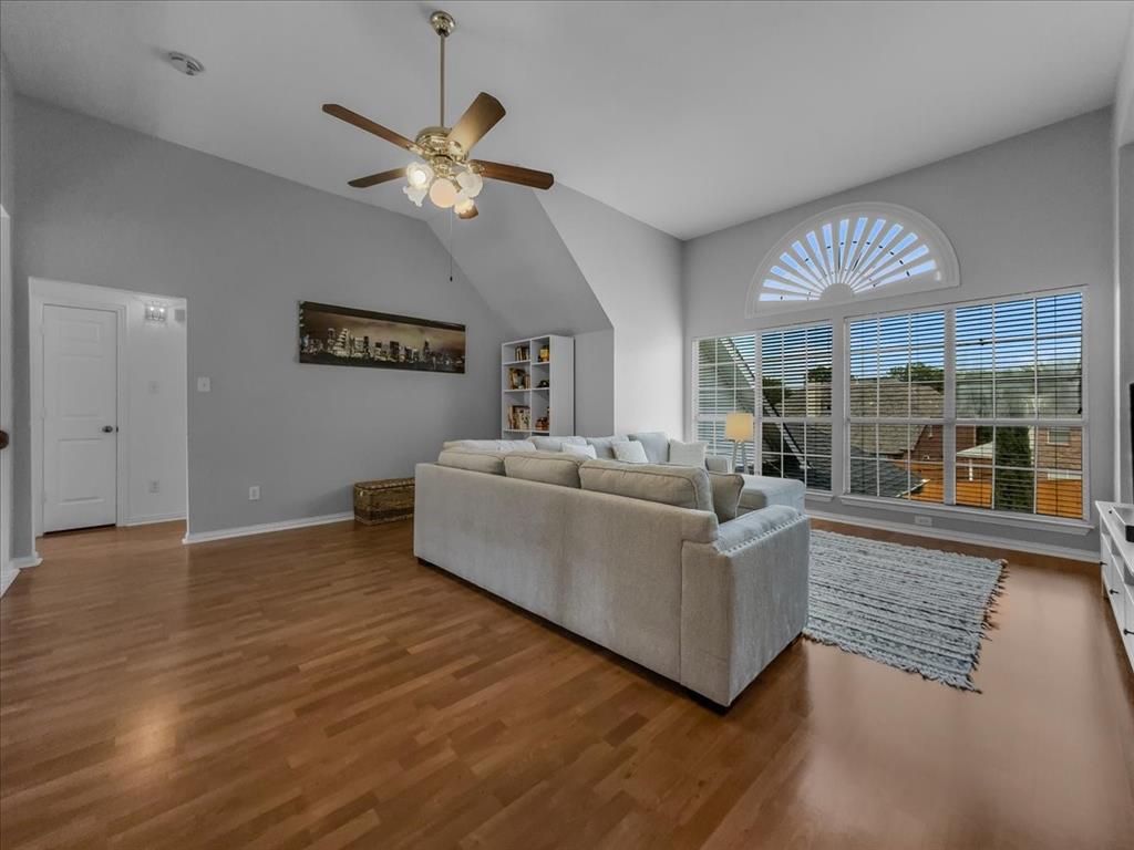 6206 Hidden Springs Lane Garland, TX 75044 - Photo 13 of 24 Family Room , on the second floor, featuring a ceiling fan, wood finished floors, vaulted ceiling, and baseboards