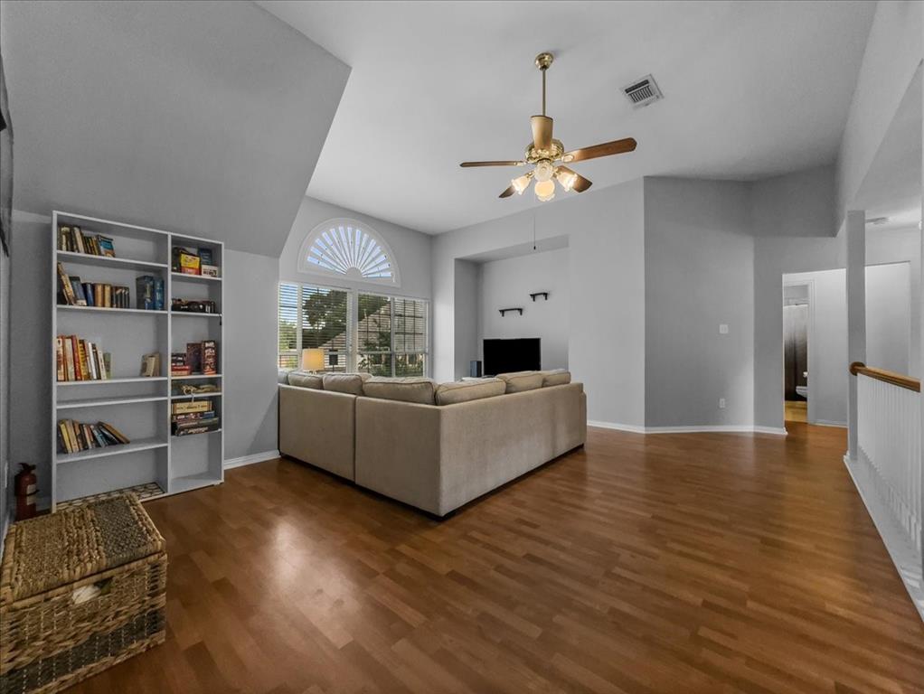 6206 Hidden Springs Lane Garland, TX 75044 - Photo 15 of 24 Family room on the second floor featuring a ceiling fan, wood finished floors, baseboards, and a high ceiling