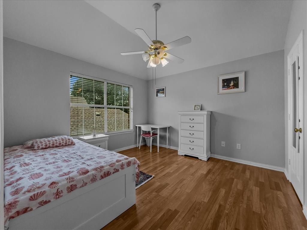6206 Hidden Springs Lane Garland, TX 75044 - Photo 18 of 24 Bedroom with wood finished floors, baseboards, vaulted ceiling, and ceiling fan
