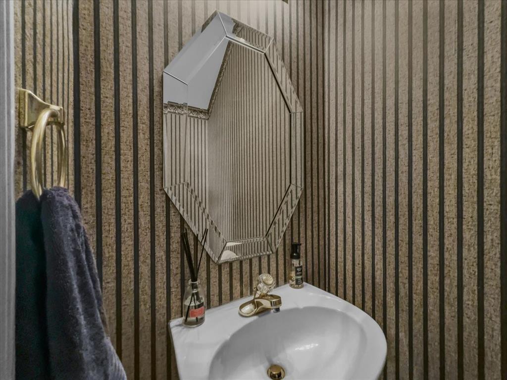 6206 Hidden Springs Lane Garland, TX 75044 - Photo 21 of 24 Guest bathroom with wallpapered walls and a sink