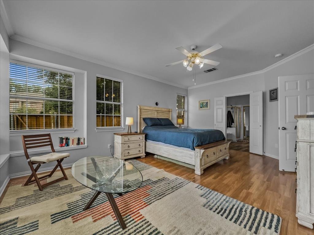 6206 Hidden Springs Lane Garland, TX 75044 - Photo 9 of 24 Bedroom featuring wood finished floors, ornamental molding, baseboards, a spacious closet, and a ceiling fan