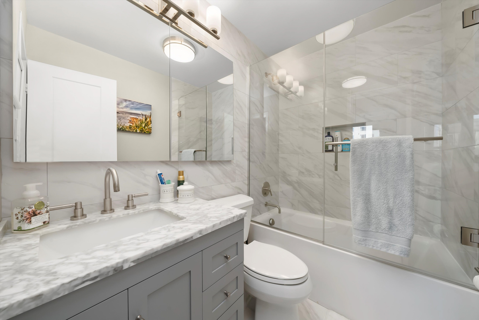 777 North Michigan Avenue, Unit 1601 Chicago, IL 60611 - Photo 20 of 44 a bathroom with a granite countertop sink a toilet a mirror and shower